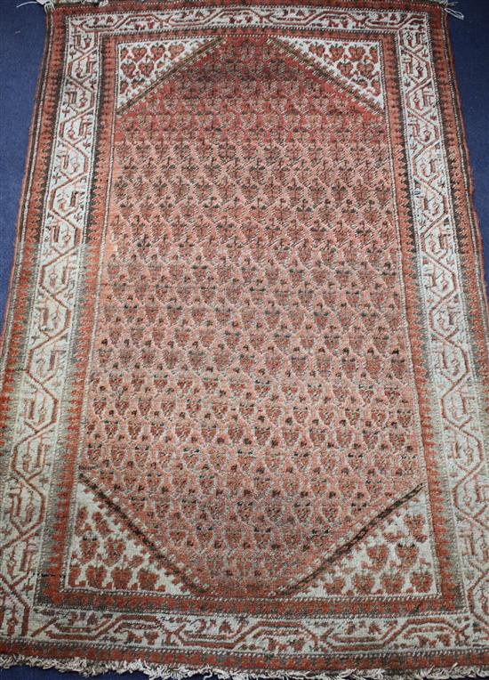 A Persian russet ground rug with central field of leaf motifs, multi-bordered, 150 x 95cm